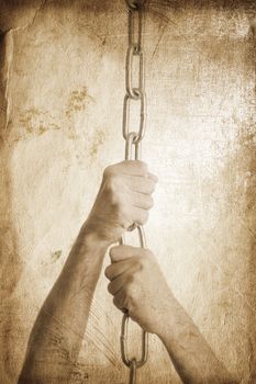 hands of man with metal chain special toned great for your design and art-work