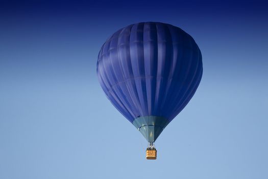 Blue hot air balloon in the air.