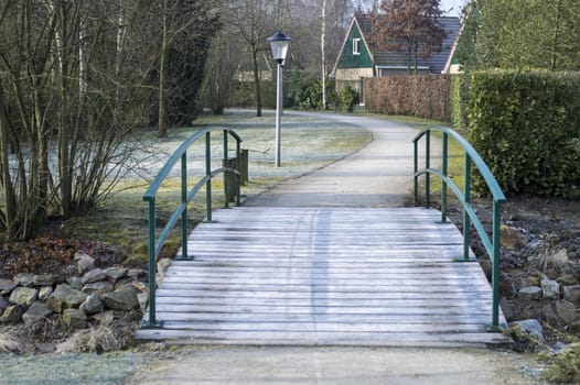 park with holiday houses and small bridge over dry river