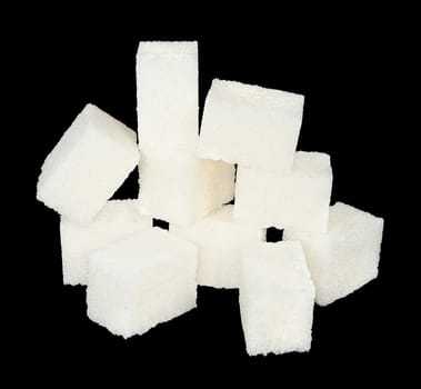 Pieces of sugar on a black background.