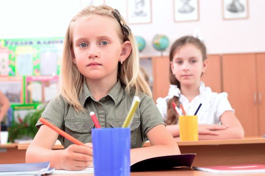 portrait of students in the classroom, sit at school desks