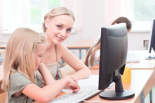 teacher explains the task schoolgirl at the computer, the new technologies in education