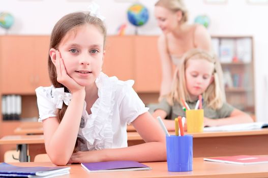 portrait of students in the classroom, sit at school desks