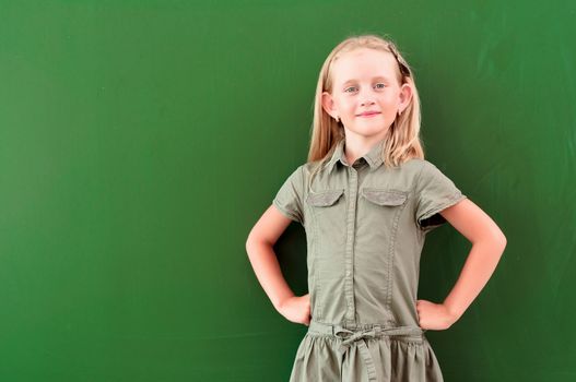 schoolgirl portrait near the blackboards, looking at the camera