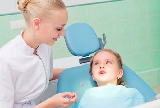 young doctor woman and girl in dentist office, regular visits to the dentist