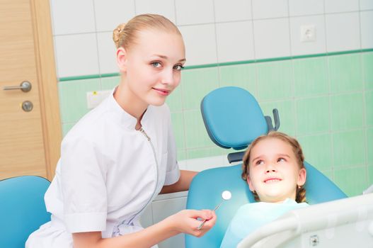 young doctor woman and girl in dentist office, regular visits to the dentist