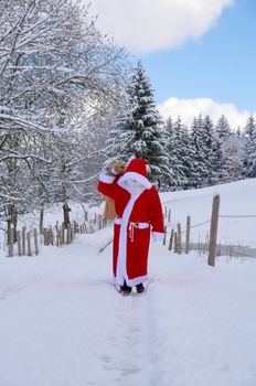 Santa Claus, Father Christmas in a beautiful winter landscape