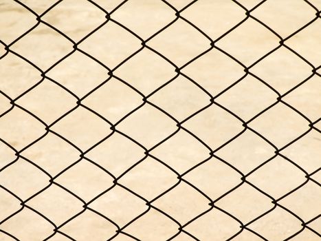 Metal net with ground on background