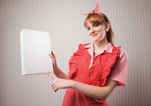 Housewife with a blank package of laundry detergent in her hand. Add your logo in it's place