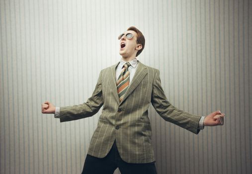 Happy businessman celebrating success with open arms