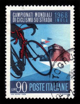 ITALY - CIRCA 1968: A stamp printed in Italy, shows racing bike and the citadel Sforza at Imola , dedicated to  world championship of road cycling in Italy, circa 1968