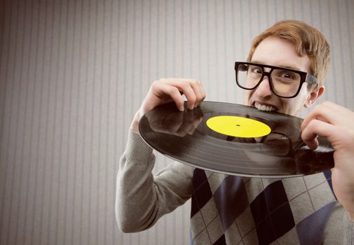 Nerd student angry, biting a vinyl record