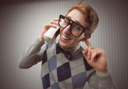 Nerd student with an old mobile phone
