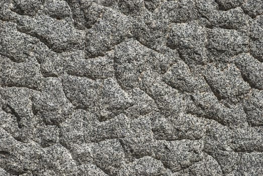 Granite block bumpy surface closeup as background