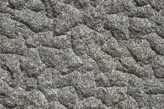 Granite block bumpy surface closeup as background