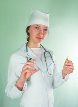 Young lady doctor with syringe against light background