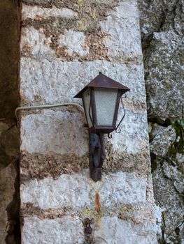 Photo of an old style lantern on a wall