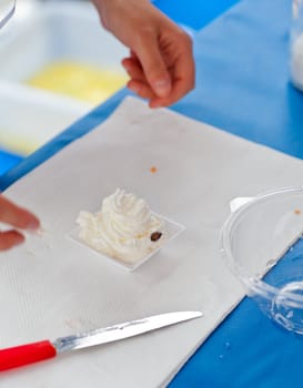 Woman preparing a dessert with cream