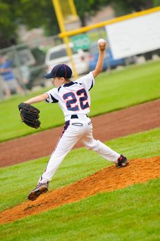 Little league baseball pitcher on the mound.