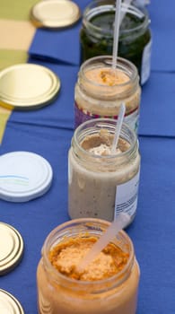 A lot of soup jars on a blue table