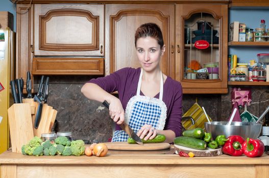 beautiful housewife cooking vegetables in the kitchen