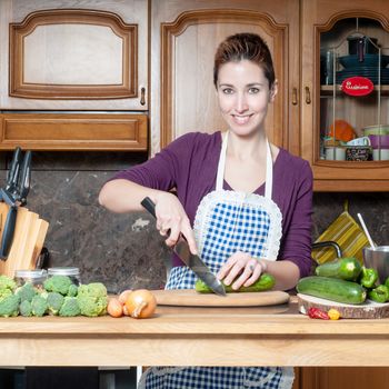 beautiful housewife cooking vegetables in the kitchen