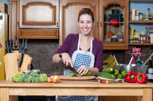 beautiful housewife cooking vegetables in the kitchen