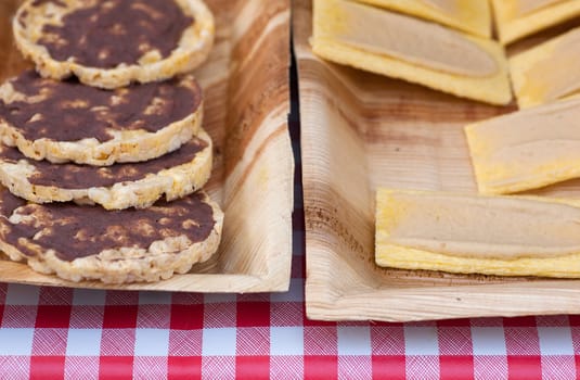 Different crackers spread with cream inside the trays