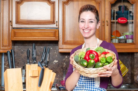 beautiful housewife with basket of vegetables in the kitchen