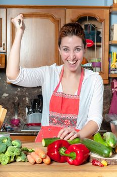 beautiful housewife cooking vegetables in the kitchen