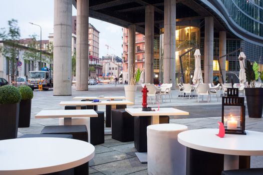 Little tables and stools in a outdoor pub