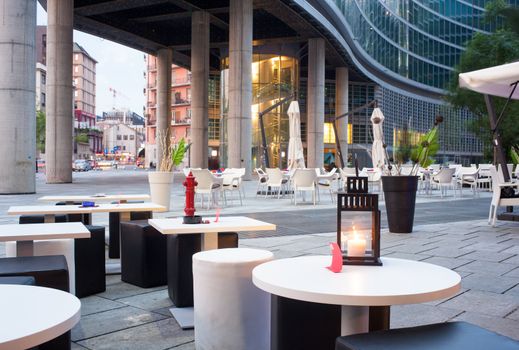 Little tables and stools in a outdoor pub