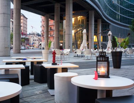 Little tables and stools in a outdoor pub