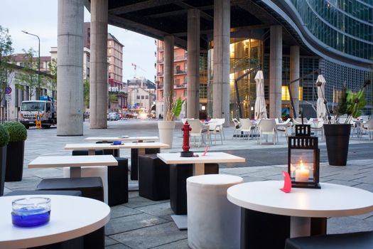 Little tables and stools in a outdoor pub