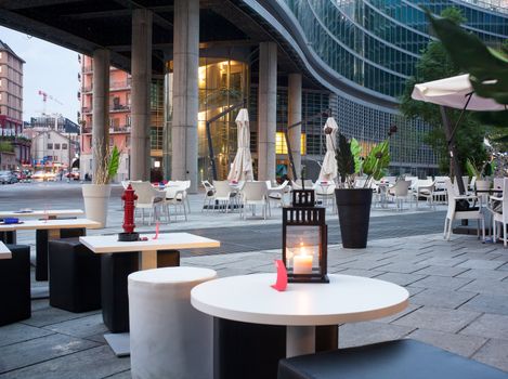Little tables and stools in a outdoor pub