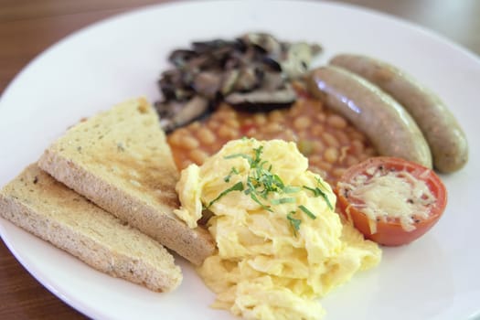 Scrambled Eggs Sausages with Bread Toast Baked Beans Sauteed Mushrooms and Tomato with Melted Cheese Breakfast