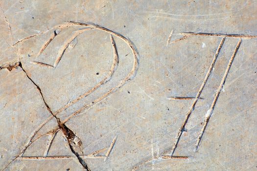 Photo of Numbers twenty-seven etched in stone