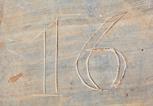 Photo of Numbers sixteen etched in stone