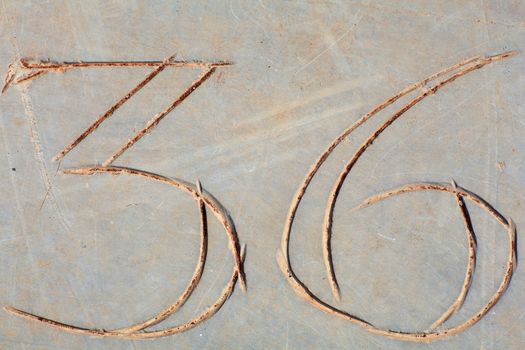 Photo of Numbers thirty-six etched in stone
