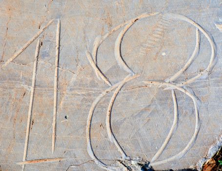 Photo of Numbers eighteen etched in stone