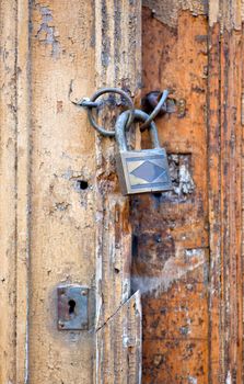 Photo of old wooden door closet with padlock