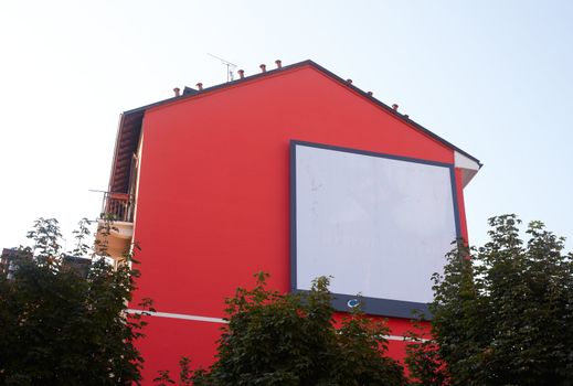 Billboard on a red house for various advertising