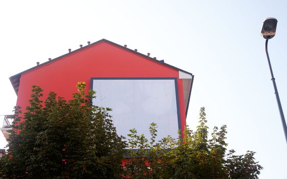 Billboard on a red house for various advertising