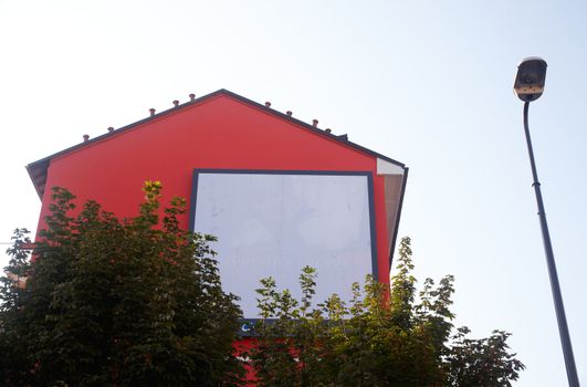 Billboard on a red house for various advertising