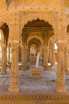 Line of arches and columns with floral classical Rajasthan ornament on ruins of Bada Bagh, Jaisalmer, India