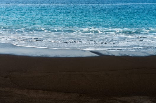 Black sand volcanic beach in Bali, Indonesia