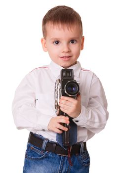 Happy young kid videograph holding a vintage video camera on a white background 