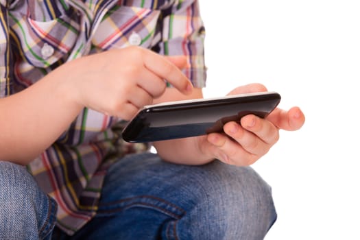 Close up of a kid hands using mobile smart phone. Selective focus on the left hand.