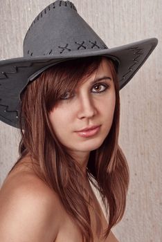 Portrait beautiful brunette in cowboy hat.