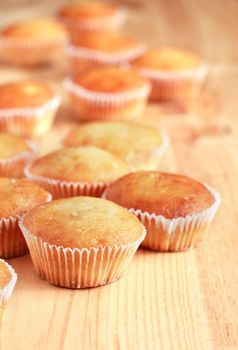 Set of  fresh-baked muffins on wooden surface